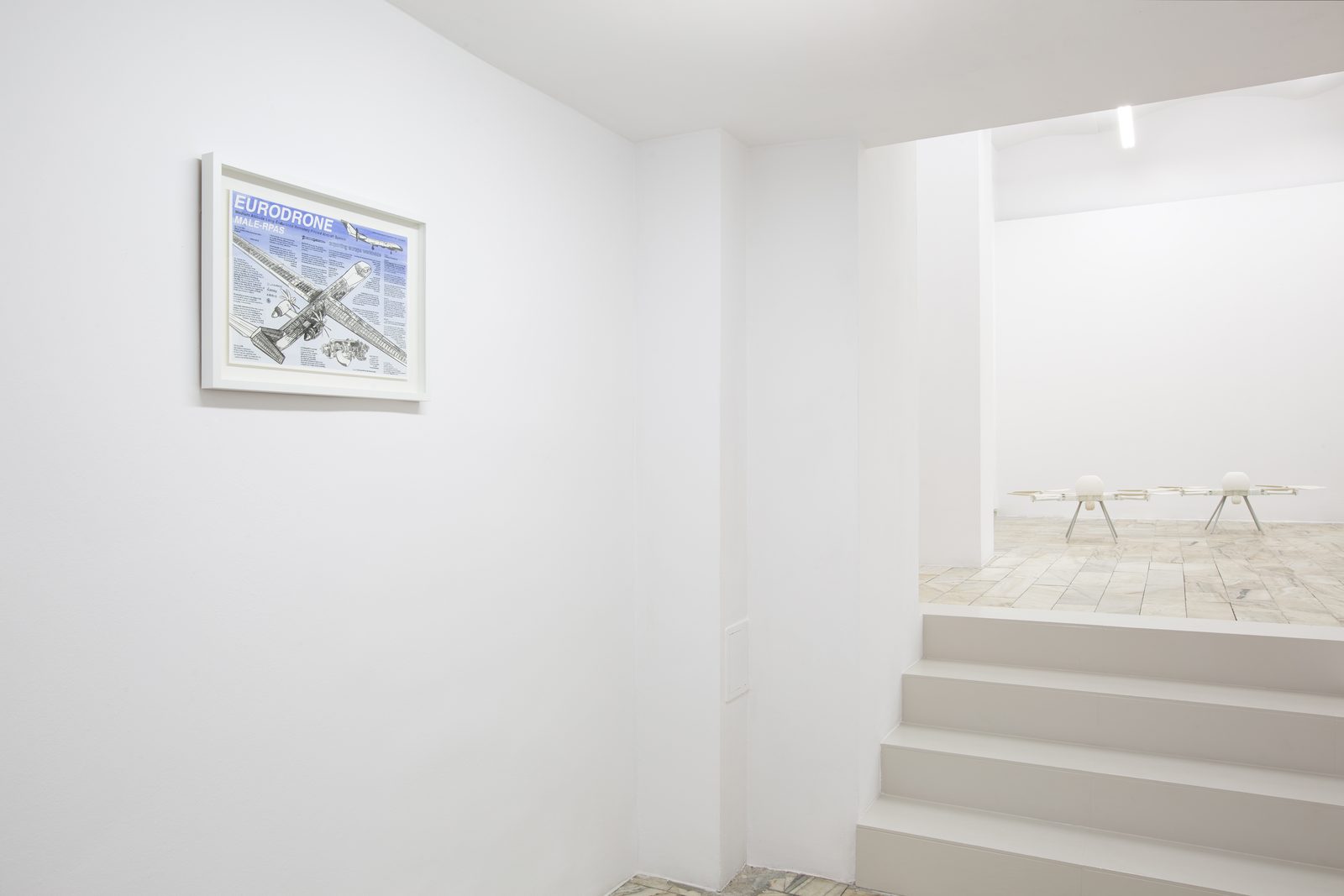 Asymmetric Futures, installation view with the framed Eurodrone drawing and the steps leading to the SWARM installation